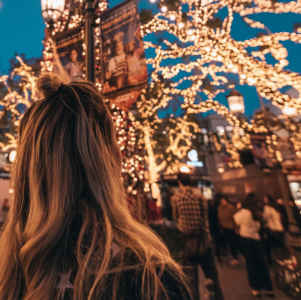 A woman admiring holiday lights and festive decorations during a Christmas event at the NJ Shore.